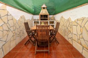 a dining room with a table and chairs and a bird feeder at Apartamento By Llu in Alcalá la Real
