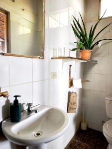 a bathroom with a sink and a toilet at El Marabu Chill'n Surf in Aposentillo