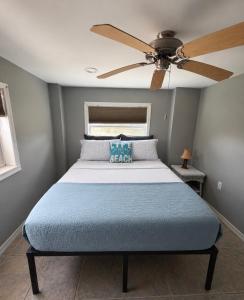 a bedroom with a bed with a ceiling fan at Driftwood Getaway Vacation home in Fort Myers Beach +67 photos