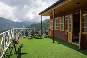 a balcony of a house with a view of the mountains at Laguna Villa Cottages in Chinkadzeebi