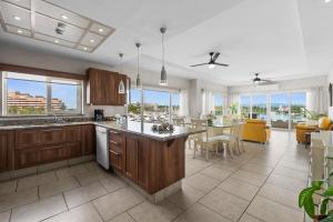 a kitchen with wooden cabinets and a dining room at Marina Banderas Suites Hotel Boutique in Nuevo Vallarta