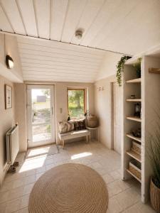 a living room with a couch and a window at Alpaca Bed & Fields in Snedsted