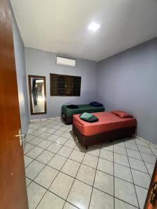 a bedroom with two beds in a room at Casa ampla central in Dourados