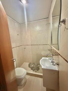 a small bathroom with a toilet and a sink at Alojamiento Yésica in Resistencia +5 photos