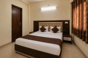 a bedroom with a large bed in a room at Hotel Galaxia Inn Near PEC College in Chandīgarh