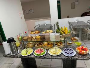 a table with many different types of food on it at Alameda Hotel Centro in Garanhuns