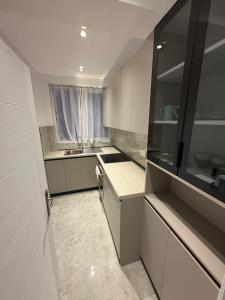 a small kitchen with a sink and a window at Durres Beach Rooms in Durrës