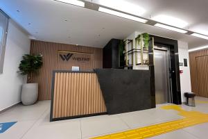 a lobby with a westation sign on the wall at Studio Nova Betânia - Barreto - in Mossoró