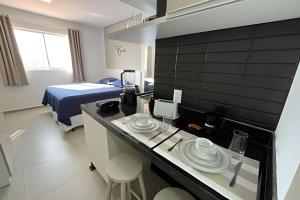 a hotel room with a kitchen and a bed at Studio Nova Betânia - Barreto - in Mossoró +52 photos