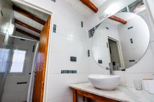 a bathroom with a sink and a mirror at Entre Hileras - Las Rabonas in Las Rabonas +8 photos