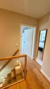 an empty room with a staircase and a mirror at Haus SandRast in Westerland