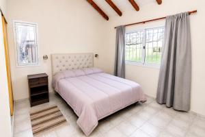 a bedroom with a bed and a window at Entre Hileras - Las Rabonas in Las Rabonas