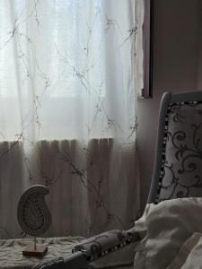 a bedroom with a chair and a window at L'Angolo Rosa B&B in Piedimonte dʼAlife