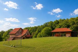 a large field with a house and a playground at Srce Baranje in Podolje