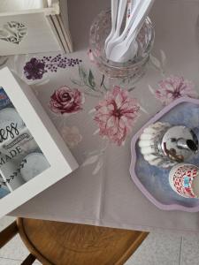 a table with a table cloth with flowers on it at L'Angolo Rosa B&B in Piedimonte dʼAlife