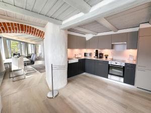 a kitchen with black cabinets and a dining room at Al Paradiso by Fewotessin in Ronco sopra Ascona
