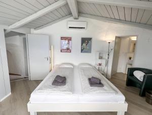 a large white bed in a white room at Al Paradiso by Fewotessin in Ronco sopra Ascona