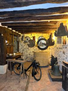 a bike parked in a room with pots and pans at Museo de las Campanas, Vierna in San Bartolomé de Meruelo