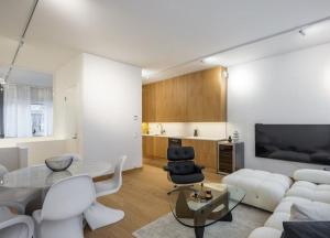 a living room with a white couch and a table at City Choice Apartment in Helsinki