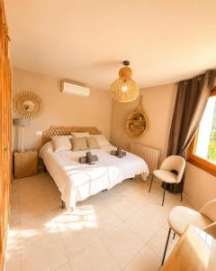 a bedroom with a large bed and a chair at Casa Toucan Moraira in Benitachell +30 photos