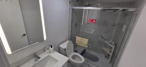 a bathroom with a shower and a toilet and a sink at La Rose des Prairies -The Prairie Rose in Calgary +20 photos