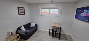 a living room with a couch and a table at La Rose des Prairies -The Prairie Rose in Calgary