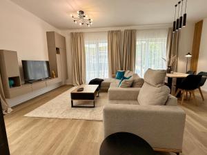 a living room with a couch and a table at Sky Residence House 5 in Cluj-Napoca