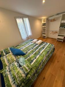 a bedroom with a bed with a quilt on it at Charmante villa in Hyères