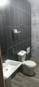 a bathroom with a toilet and a sink at Nakhili in Keur Massar