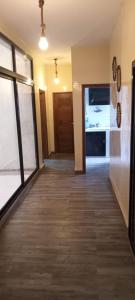 a hallway of a house with a door and a kitchen at Nakhili in Keur Massar