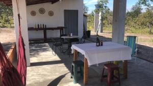 a table and chairs sitting on a patio at Hostel Itapiru in Mateiros