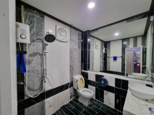 a bathroom with a toilet and a sink and a shower at The loft 2 in Ban Khlong Khwang Klang