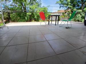 a patio with two chairs and a table at Hospedaje Cosquin in Cosquín