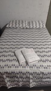 a bed with two pillows on top of it at Hostel Itapiru in Mateiros +4 photos