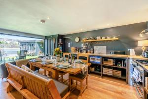 a dining room with a table and a kitchen at 3 Bed in Bideford oc-79552 in Bideford