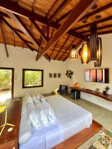 a large bed in a room with wooden ceilings at Pousada Ka 347 in Itaúnas +64 photos