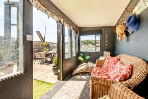 a porch with a wicker couch and a patio at 3 Bed in Bideford oc-79552 in Bideford