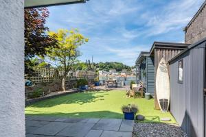 a backyard with a lawn with a surfboard at 3 Bed in Bideford oc-79552 in Bideford