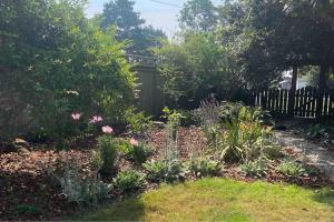 a garden with many flowers and a fence at Rock Rose Cottage in Trinidad