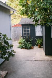 a small blue building with a window and plants at Rock Rose Cottage in Trinidad +47 photos