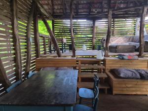 a room with two beds and a table and chairs at Kamp Kalavat in Vrtovac