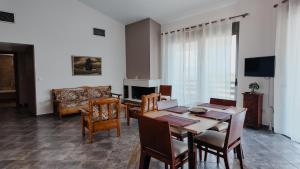a dining room with a table and chairs and a couch at Platanos View in Plátanos
