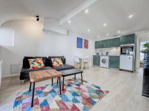 a living room with a couch and a table at Le Grand Sault - Hyper-Centre in Grenoble