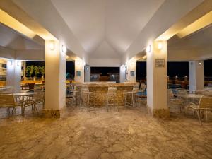 a large room with tables and chairs and lights at Golden Dream Studio 2nd floor B in Isabela
