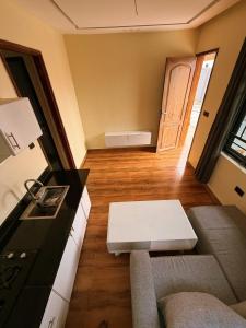 a small living room with a couch and a table at Nungwicozy stay in Kinyasini