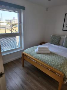 a bedroom with a bed and a large window at Quayside Waters in Dundee