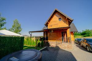 a small wooden house with a grill in front of it at LUX PINE house in Zlatibor