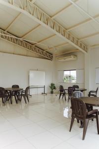 an empty room with tables and chairs and a white wall at Bella Vista Hotel - Encarnación in Encarnación +111 photos