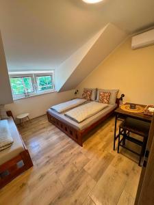 a large bedroom with a bed and a table at Ubytování U Špíšků in Jaroslavice