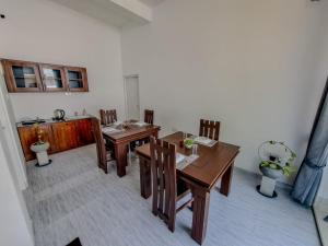 a dining room with a table and chairs and a sink at Shalom Resorts Yala in Tissamaharama